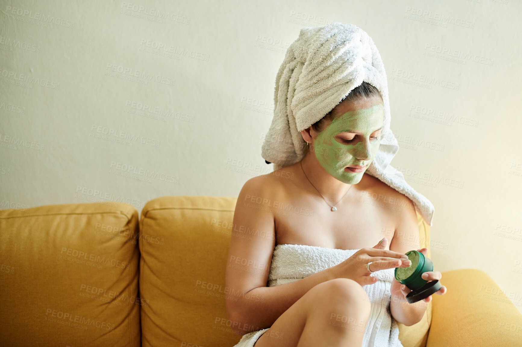 Buy stock photo Facial mask, treatment and woman using cosmetic product on her face for beauty, skincare and self care in her home or house. Detox by female cleaning her skin as morning routine while she relax