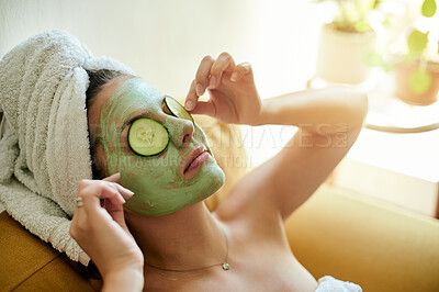 Buy stock photo Facial, spa and woman with cucumber on eyes or face for vitamin c, wellness and natural beauty lying on a couch or sofa. Relax, dermatology and happy female using vegetable to detox for skincare