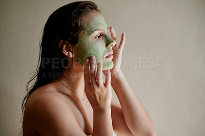Buy stock photo Face, beauty and woman using cosmetic product for facial treatment, skincare and self care isolated in studio background. Detox, mask and female cleaning her skin for morning routine while she relax