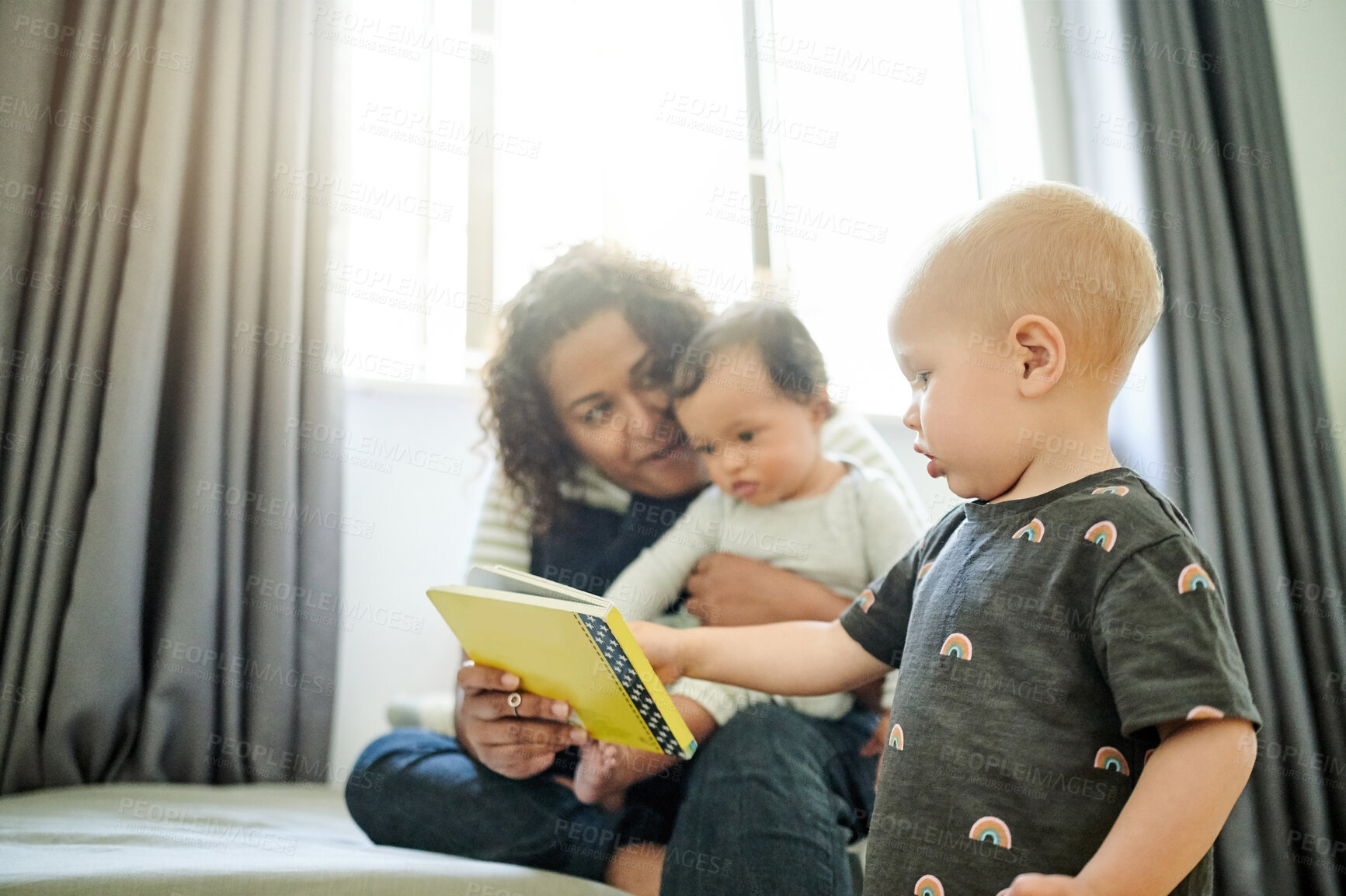 Buy stock photo Mother, babies and learning with book in home, storytelling and education in house. Development, care and happy mama reading with children, kids or toddlers while bonding and having fun together.
