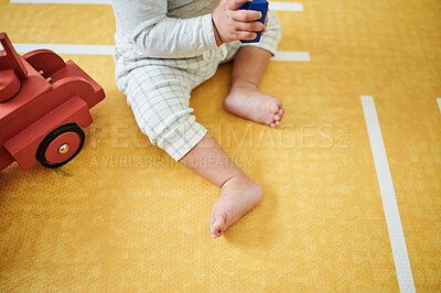 Buy stock photo Feet, nursery and baby play with toys for educational games, playing and child development at home. Toddler, childcare and kid relax with toy truck, building blocks and having fun learning in bedroom