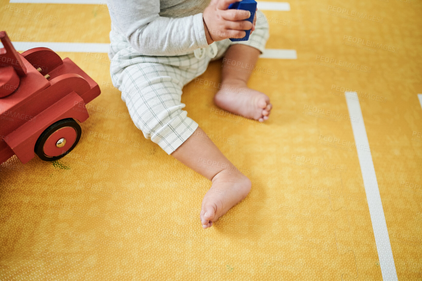 Buy stock photo Feet, nursery and baby play with toys for educational games, playing and child development at home. Toddler, childcare and kid relax with toy truck, building blocks and having fun learning in bedroom