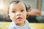 Newborn, nursery and face of baby with cute, adorable and curious expression in childhood bedroom. Family, children and young kid relaxing on floor for child development, growth and calm at home