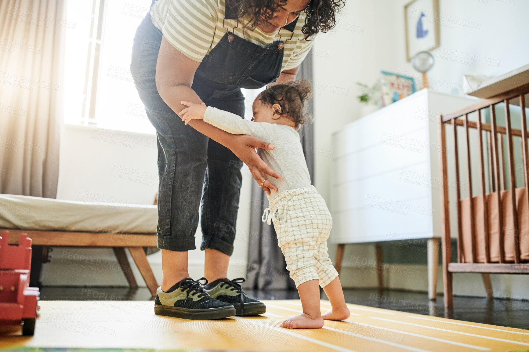 Buy stock photo Mother, baby and learning to walk in home, education and bonding in house nursery. Care, development and mama teaching kid, toddler or newborn walking, helping and balance, support and first steps.