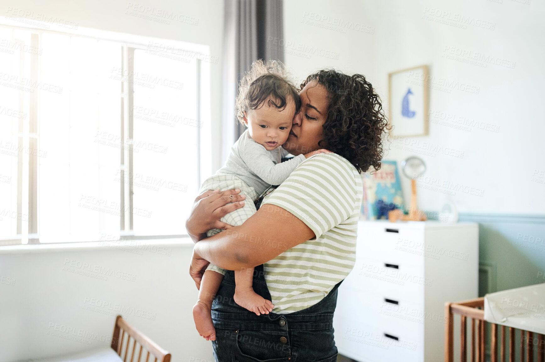 Buy stock photo Love, mother and kiss baby in home, bonding and care, affection and nurture. Development, childhood and mama kissing foster kid, carrying toddler or newborn, hugging and embrace together in house.