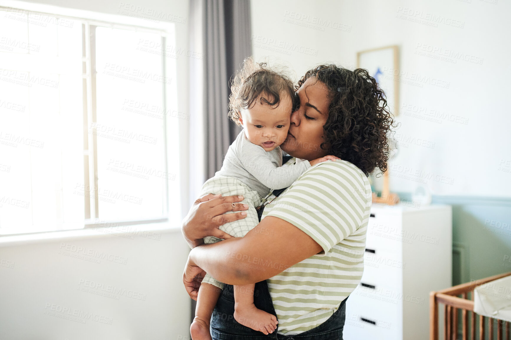 Buy stock photo Love, mother and kiss baby in home, bonding and care, affection and support. Development, childhood and mama kissing foster kid, carrying toddler or newborn, hugging and embrace together in house.