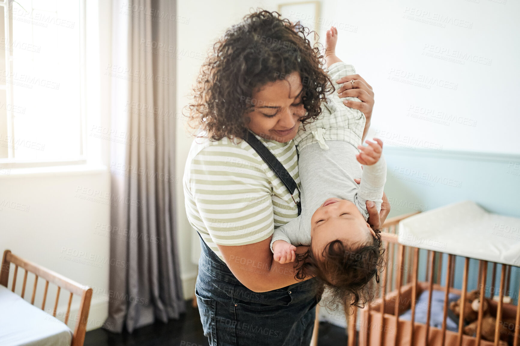 Buy stock photo Happy, playful and a mother holding a baby, bonding and playing in a nursery room. Smile, funny and a woman with a child for play fun, quality time and happiness together at home in the morning