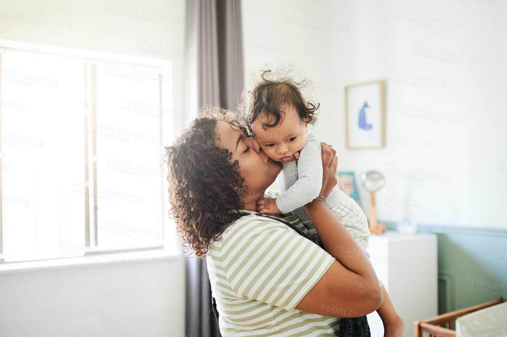 Buy stock photo Love, kiss and mom with her baby in his nursery bonding, playing and connecting at their home. Happiness, smile and young woman holding her infant newborn boy in the bedroom of their modern house.