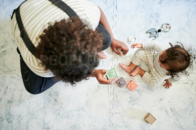 Buy stock photo Baby, mother and building blocks from above a floor for education, bonding and playing in their home. Learning, toys and top view of child development by parent and toddler having fun with cube game