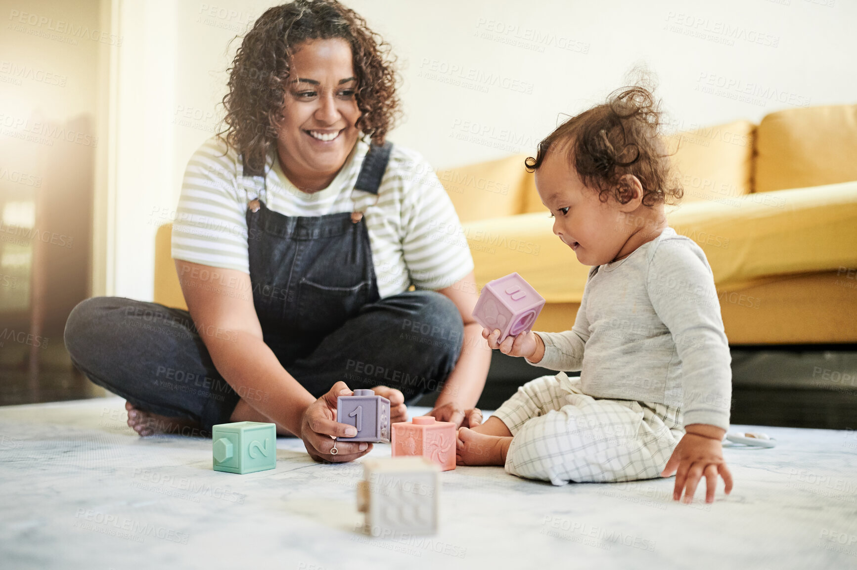 Buy stock photo Mother, baby and building blocks on a living room floor for education, bonding and playing in their home. Learning, toys and child development with mother and toddler having fun with educational game