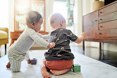 Buy stock photo Baby building, home and kid toys for mobility development and learning together in a bedroom. Nursery, toy brick and cute children back curious about youth game and activity in a house on the floor