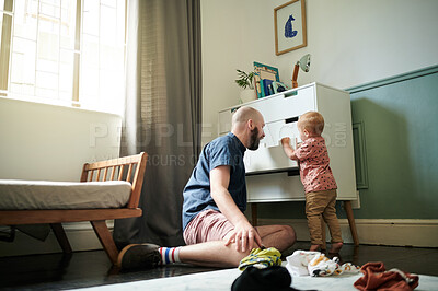 Buy stock photo Getting ready, children and a man helping his son to pick an outfit from the cupboard in a bedroom. Kids, clothes and dressing with a young father teaching his toddler child about chores or packing