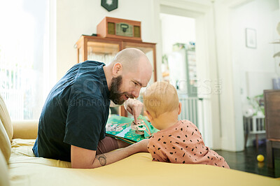 Buy stock photo Baby, father and reading story book on a sofa in a family home living room for fun. Male person or dad with toddler kid for quality time, love and fairytale while learning, talking and happy together