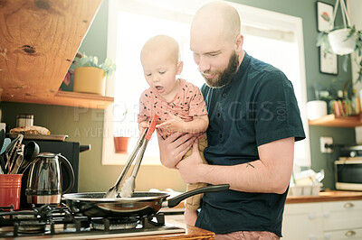 Buy stock photo Cooking, kitchen and a dad at home with his baby in the morning together for food or lunch preparation. Family, children or kids with a parent and infant boy in a house to make a meal while bonding