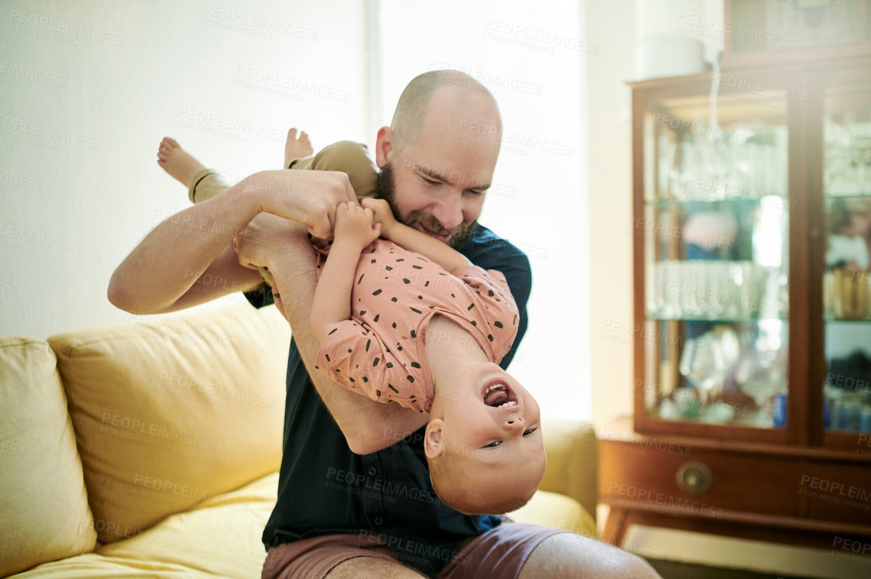 Buy stock photo Love, father and kid upside down, playing and bonding at home, cheerful and happiness. Family, male parent and happy dad with child, young person and laughing in the living room, flipping and loving