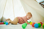 Baby, child and playing with toys in home bedroom with a tent for fun and growth development. Male toddler or kid with color balls for learning, education or game for happiness and creativity