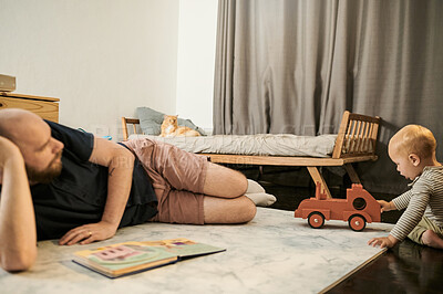 Buy stock photo Toy truck, father and baby playing in a family home bedroom for fun, growth and development. Man or dad with toddler kid, book and toys for quality time, bonding and learning together on floor