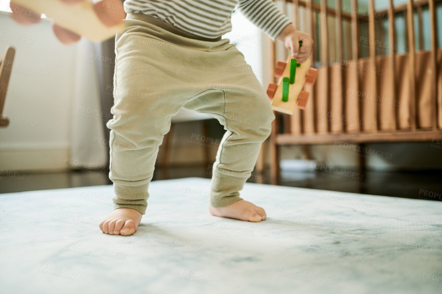 Buy stock photo Walking, learning and growth with feet of baby in nursery for child development, hope and education. Faith, cute and trust with first steps of infant at home for for youth, childhood and support