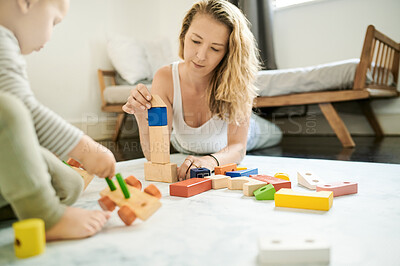 Buy stock photo Wooden blocks, baby toys and mother playing with child in family home bedroom for fun. Woman or mom with toddler child together for quality time, learning and building mobility or growth development