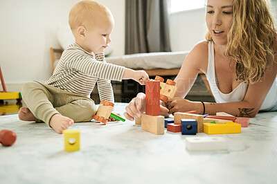 Buy stock photo Baby toys, learning and building blocks with mother and child playing in a family home bedroom for fun. Woman or mom with toddler kid together for quality time, mobility and growth development