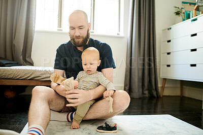 Buy stock photo Help, shoes and father with baby in living room for ready, morning routine and clothes. Bonding, support and dressing with man and young child in family home for happy, change and learning