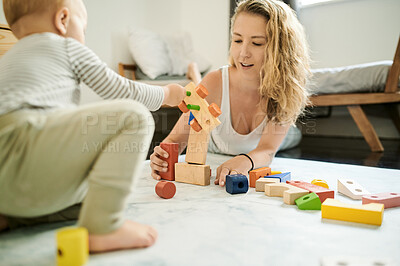 Buy stock photo Mother, child and playing with baby toys or learning blocks in a family home bedroom for fun. Woman or mom with toddler child together for quality time, happiness and building or growth development