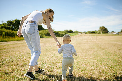Buy stock photo Mother, baby and holding hands in a field for adventure, trip and walking in nature while bonding. Love, travel and woman with child in countryside, having fun playing and learning to walk in Mexico