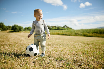 Buy stock photo Soccer, sports and baby with ball in field for playing, having fun and adventure in countryside. Childhood, fitness and happy boy outdoors for games for learning, football and weekend in nature