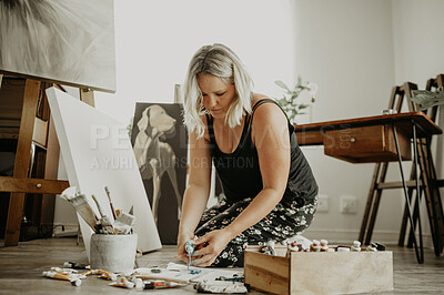 Buy stock photo Paint, canvas and girl on floor at studio for artwork with project for passion with colour at house. Workshop, female artist and mixing with tube for oil painting with inspiration for hobby to relax.
