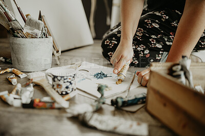 Buy stock photo Paint, paper and creative person in studio, art and watercolor supplies, equipment and closeup of canvas. Artistic talent, brush on floor in workshop with painter and artist with tools for creativity