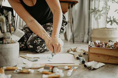 Buy stock photo Painter, paper and creative woman with tube of paint, art and equipment with closeup of painting process. Artistic talent, female person on floor in workshop and artist with tools for creativity
