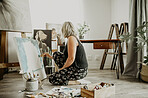 Woman, painting and creative art in studio, home or house with brush, paint and canvas. Artist person and relax painter with talent for design in workshop