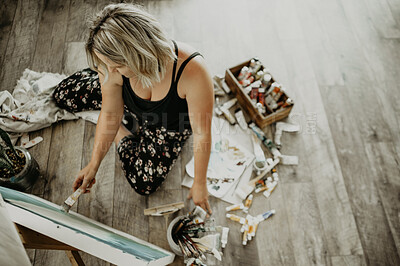 Buy stock photo Art, creativity and painting, woman in studio at home with brush, canvas and inspiration with colors from above. Paint, tools and talent, professional artist with vision and freedom for creative work