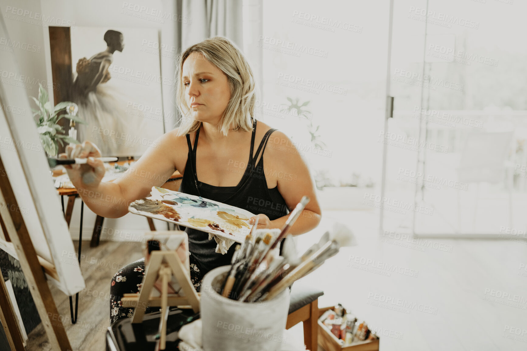 Buy stock photo Creative, art and woman is painting in studio, palette and canvas for designer talent. Creativity, artistic and female artist with brush at easel for craft with concentration, inspiration and painter