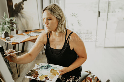 Buy stock photo Art, focus and painting, woman in studio at home with brush, canvas and inspiration in color creativity. Paint, tools and talent, professional artist or painter with idea and freedom in creative work