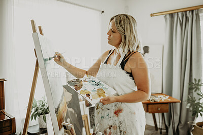 Buy stock photo Painting, canvas and woman in studio in home for creative hobby, artistic creation and design. Art, painter and female person with paintbrush for watercolor drawing and illustration in workshop