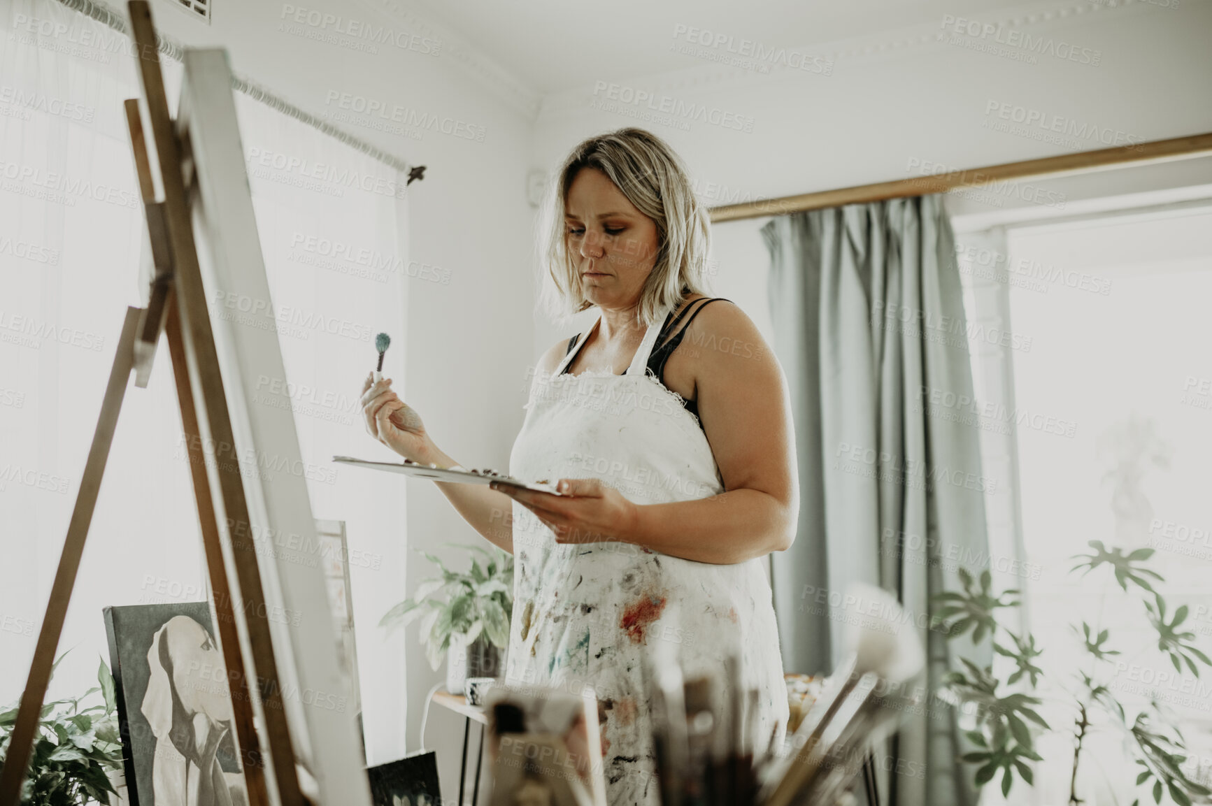 Buy stock photo Thinking, painting and woman with easel in studio for creative hobby, artistic creation and design. Art, painter and female person with paintbrush for watercolor drawing or illustration in workshop