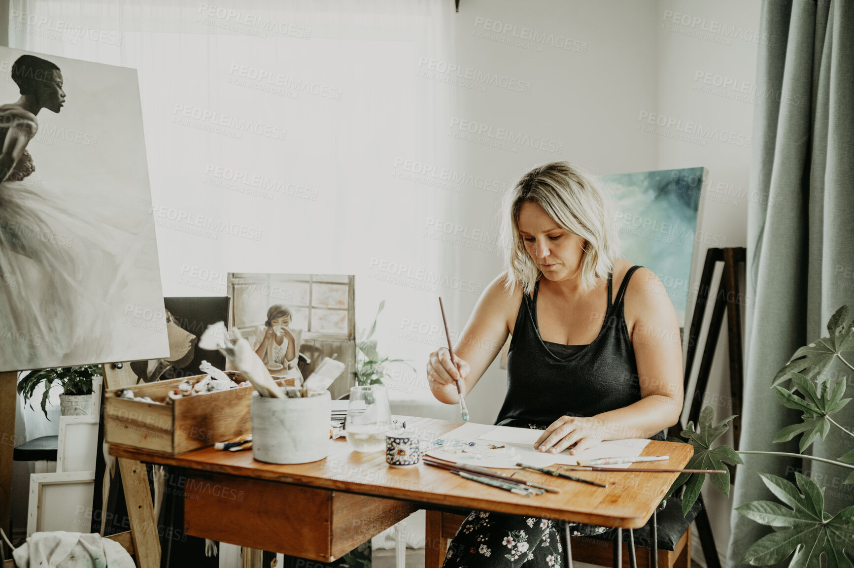 Buy stock photo Creativity, studio and woman painting in her house on a canvas with creative vision, focus and inspiration. Art, painter and young female artist creating an artwork design with a brush at her desk.