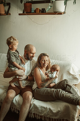 Buy stock photo Happy family, bond and parents with baby and toddler on sofa with smile, care and relax in their home together. Newborn, love and mother and father with children in a living room enjoying parenthood