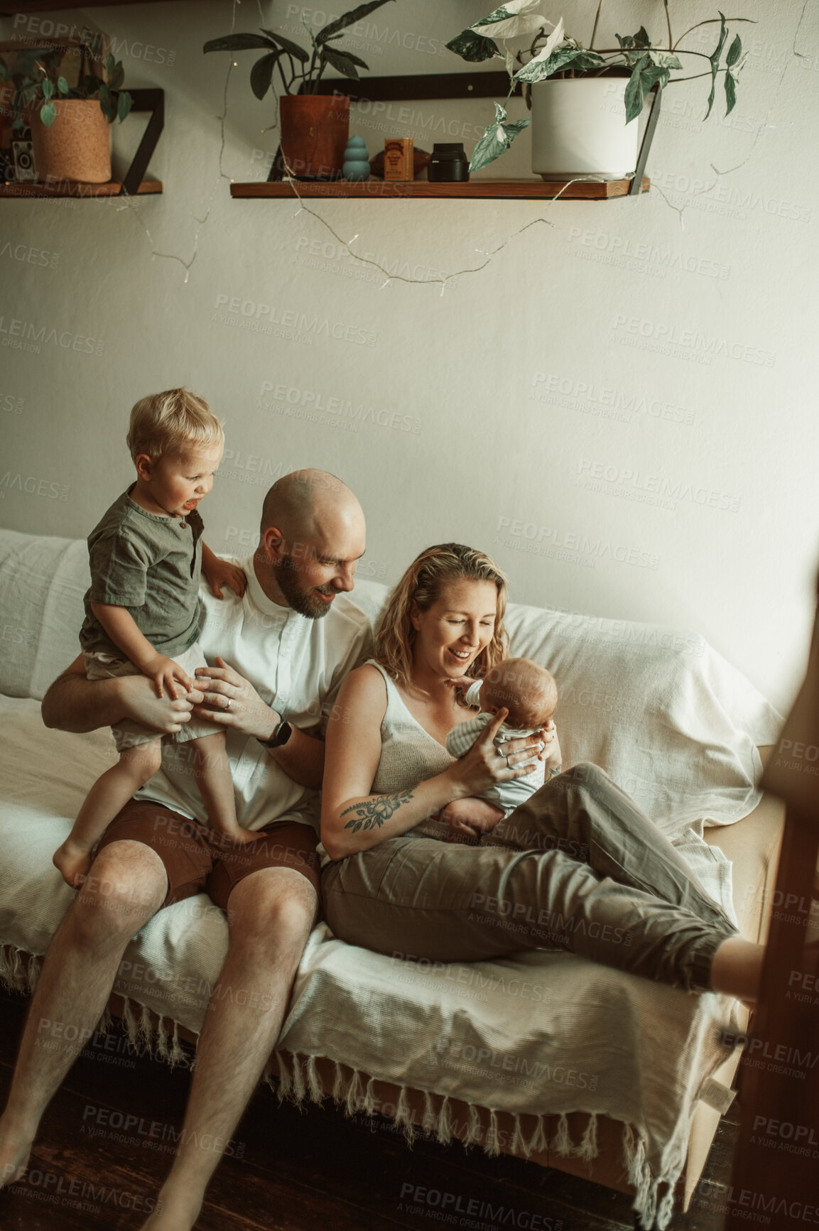 Buy stock photo Parents, children and love with a family on the sofa in the living room of their home together for bonding. Mother, father and kids in the house with a baby and cute boy child in the lounge to relax