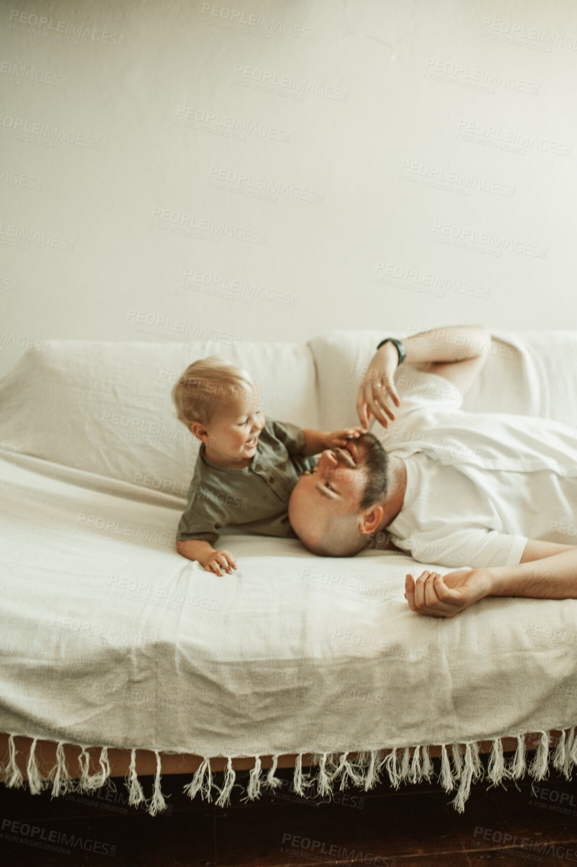 Buy stock photo Father, happy child and play in home for love, care and bonding together on sofa. Dad, boy and cute kid smile, having fun and enjoying quality time in house living room with parent on couch in lounge