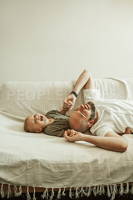 Buy stock photo Funny, father and son on a couch, humor and family with happiness, bonding and loving together. Male parent, happy boy or kid on a sofa, child development and laughing with joy, home and quality time