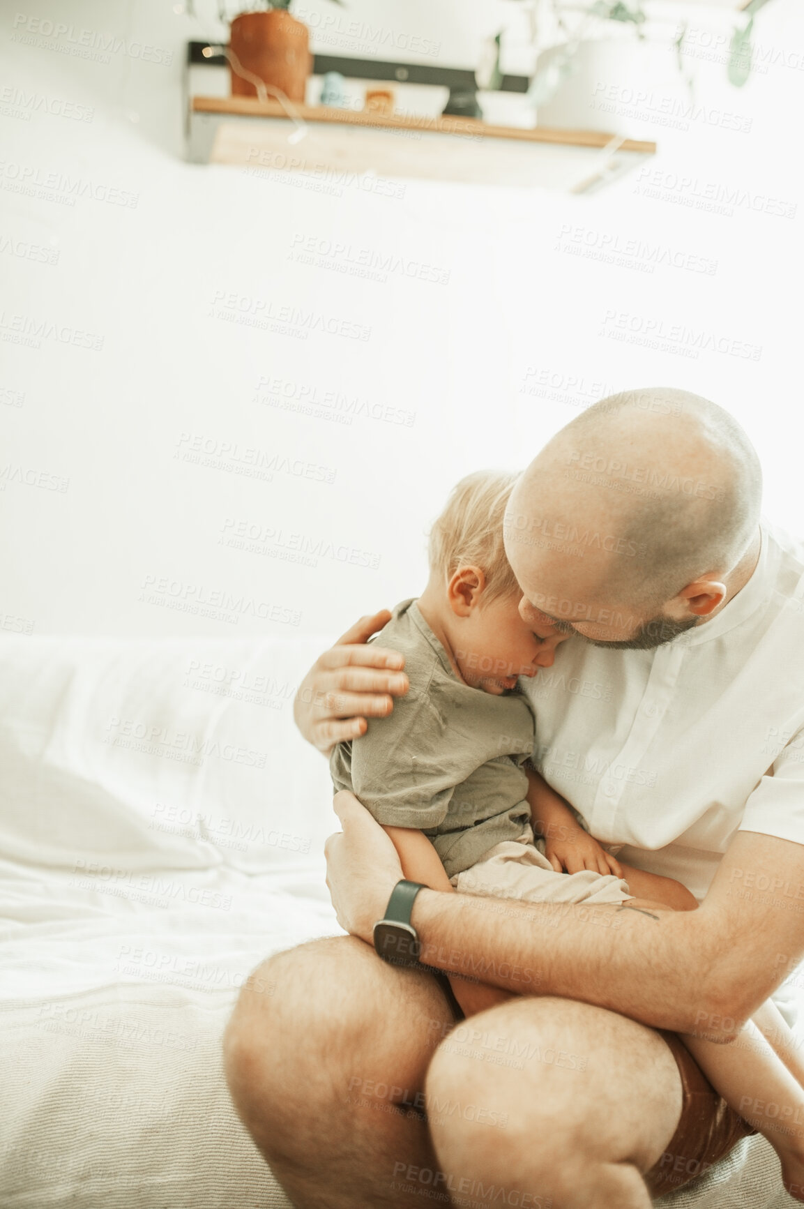 Buy stock photo Dad, kid and kiss in home for love, care and bonding together on sofa. Father, boy and hug sad child, sick or embrace crying toddler in house living room with tired parent sitting on couch in lounge.