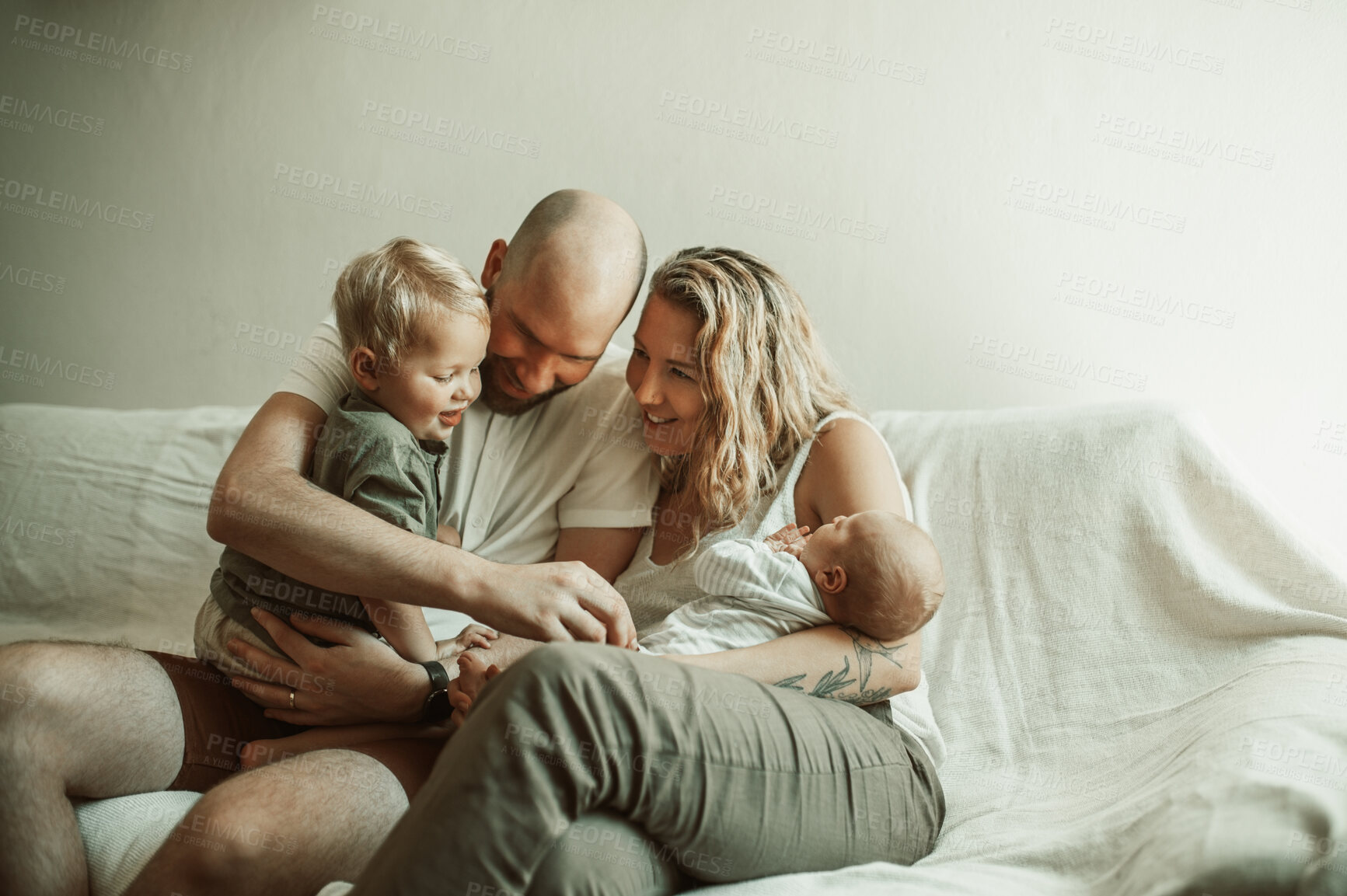 Buy stock photo Newborn, relax and family on a couch, love and happiness with bonding, care or quality time in a lounge. Parents, mother or father with their children, sofa or happy with joy, home or loving together