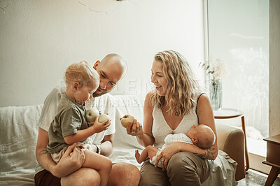 Buy stock photo Mom, dad and baby with family on couch, sofa or quality time together in living room, home or house. Mother, father and parents to love, support or care for young children, kids and embracing babies 