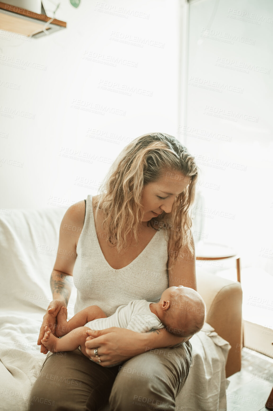 Buy stock photo Mother, holding baby in home and love, care and bonding together on sofa. Mama, newborn and cute kid, infant or toddler in comfort, relax and playing while enjoying quality time on living room couch.