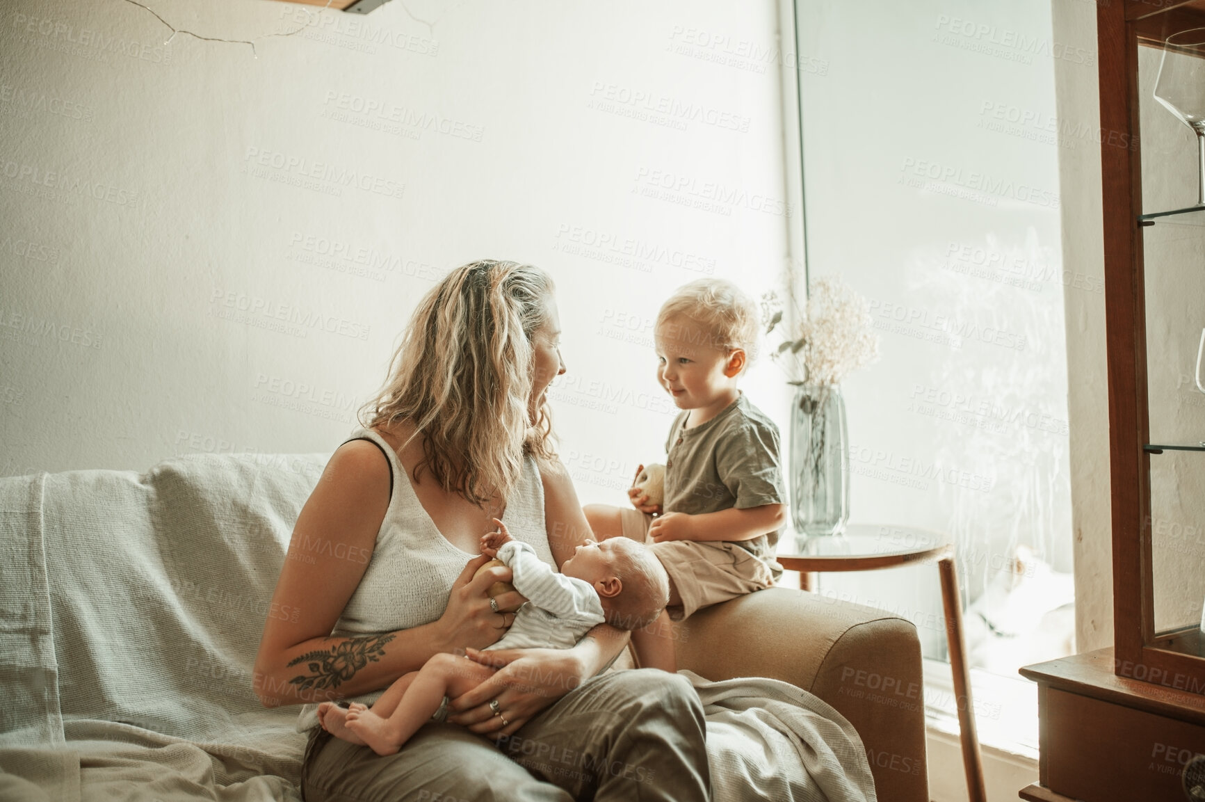 Buy stock photo Family, mother and children on a couch, love and happiness with joy, home and quality time. Female parent, baby and toddler with mama, childhood and bonding with peace, talking and rest in a lounge