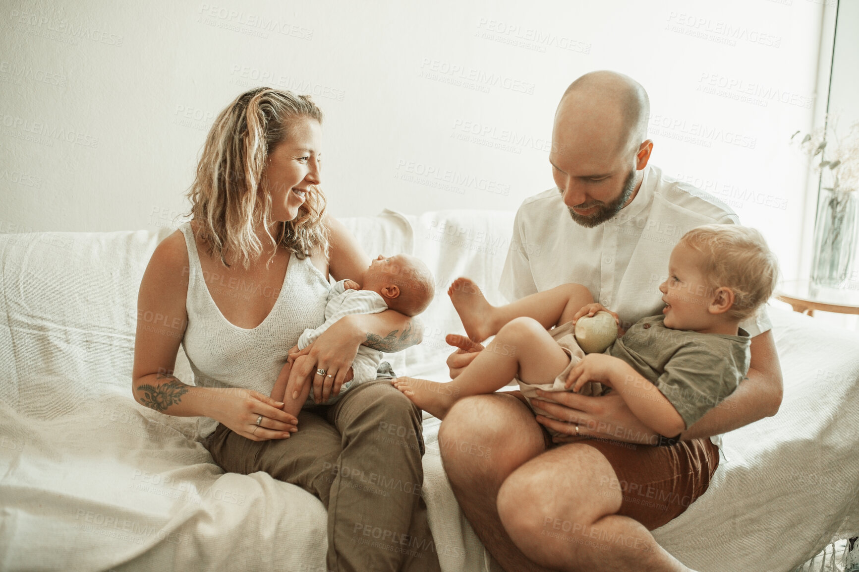 Buy stock photo Parents, children and fun with a family on the sofa in the living room of their home together for bonding. Mother, father and kids in the house with a newborn baby and cute boy child in the lounge