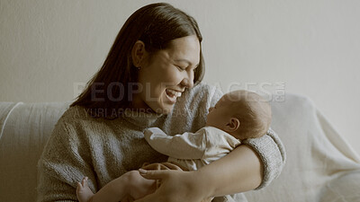 Buy stock photo Happy, love and mother with her newborn on a sofa for relaxing, bonding and resting in living room. Smile, care and young mom holding her infant, baby or child with happiness in lounge of family home