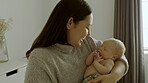 Happy, love and woman with her newborn child in a modern bedroom in the family house. Smile, care and young mother holding her infant, baby or kid for bonding with happiness in nursery at home.